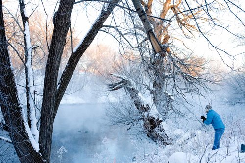 Snowy scene by the riverbank